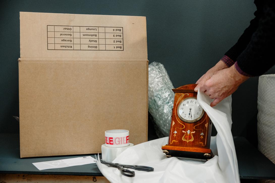 A clock being packaged up ready for delivery