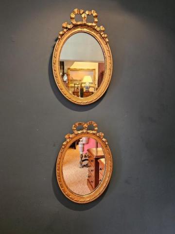 Pair of Oval Ribbon Pediment Gilt Mirrors